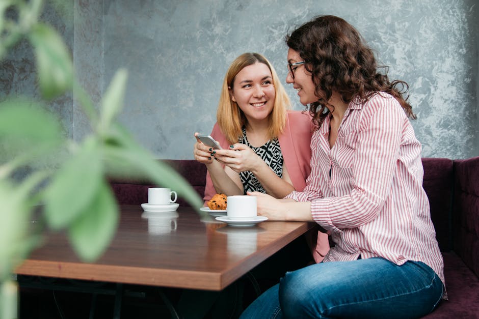 pexels-photo-2040747-2040747 Two women enjoying a conversation over coffee and cupcakes in a cozy cafe setting.